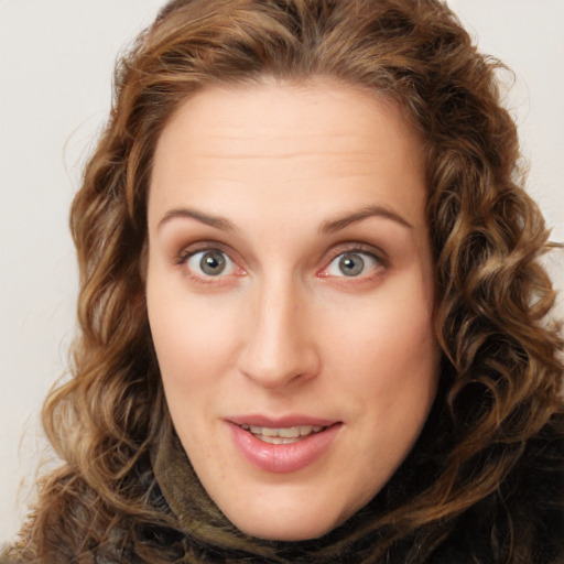 Joyful white young-adult female with long  brown hair and green eyes