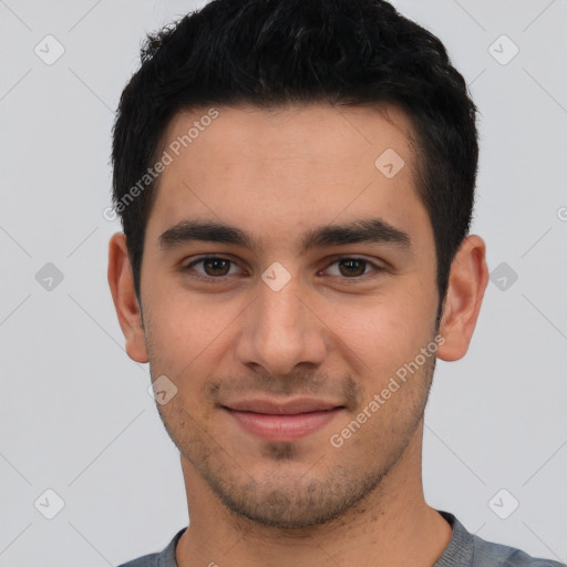 Joyful white young-adult male with short  black hair and brown eyes