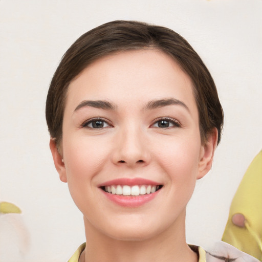 Joyful white young-adult female with short  brown hair and brown eyes