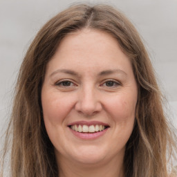 Joyful white young-adult female with long  brown hair and grey eyes