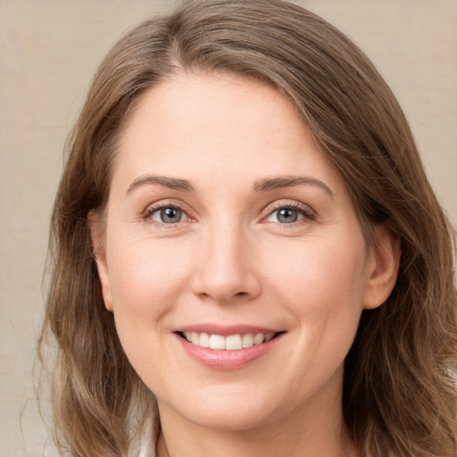 Joyful white young-adult female with long  brown hair and green eyes