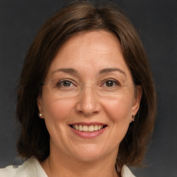 Joyful white adult female with medium  brown hair and grey eyes