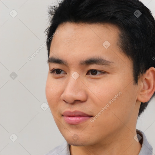 Joyful asian young-adult male with short  black hair and brown eyes