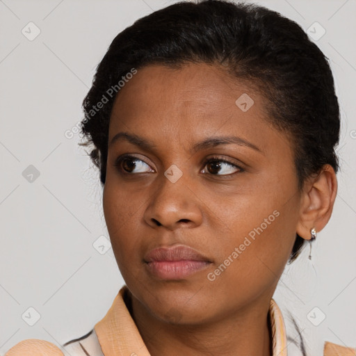 Joyful black young-adult female with short  brown hair and brown eyes