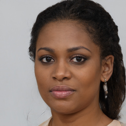 Joyful black young-adult female with medium  brown hair and brown eyes