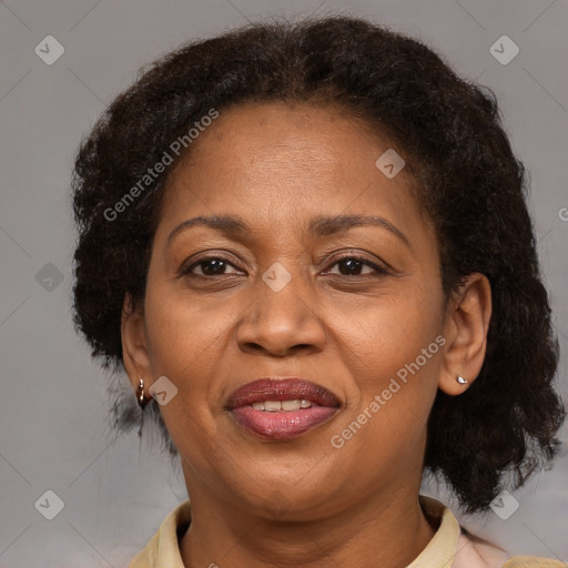 Joyful black adult female with medium  brown hair and brown eyes