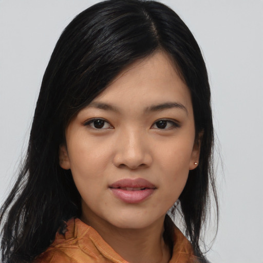 Joyful asian young-adult female with long  black hair and brown eyes