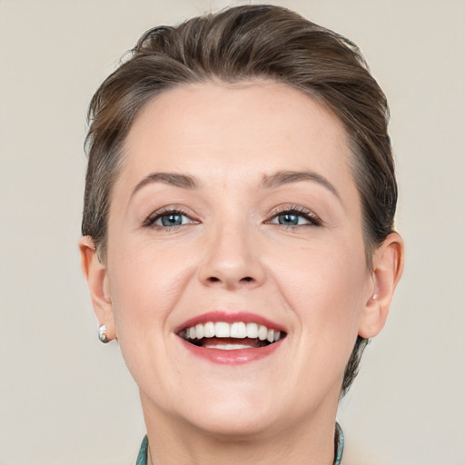 Joyful white adult female with short  brown hair and grey eyes