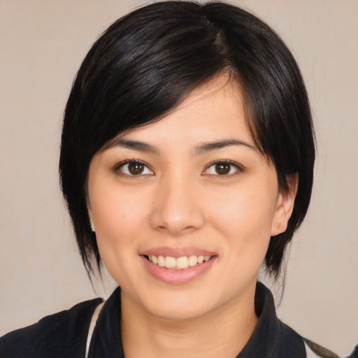 Joyful asian young-adult female with medium  black hair and brown eyes