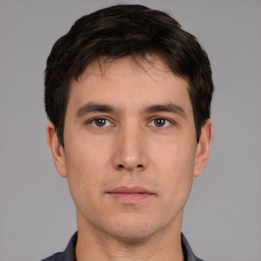 Neutral white young-adult male with short  black hair and brown eyes