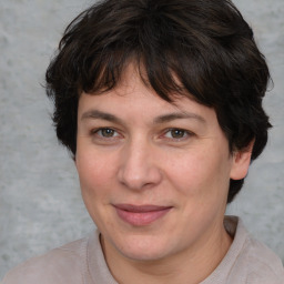 Joyful white adult female with medium  brown hair and brown eyes