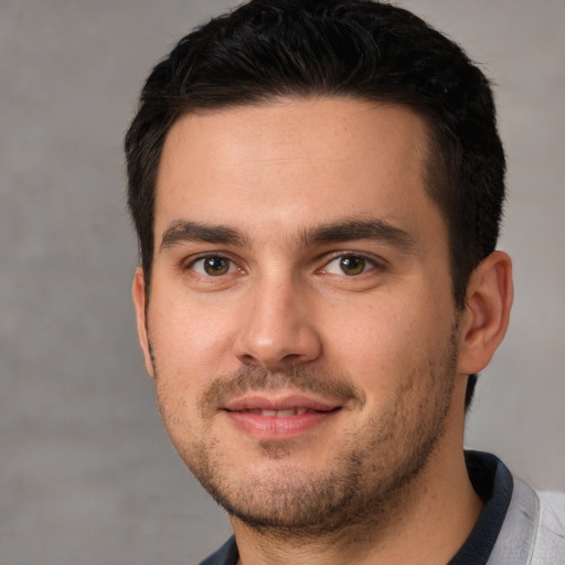 Joyful white young-adult male with short  brown hair and brown eyes