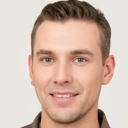 Joyful white young-adult male with short  brown hair and grey eyes