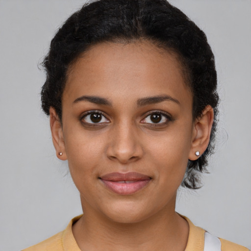 Joyful latino young-adult female with short  brown hair and brown eyes