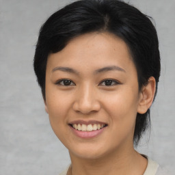 Joyful asian young-adult female with short  brown hair and brown eyes