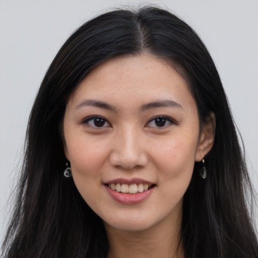 Joyful asian young-adult female with long  brown hair and brown eyes