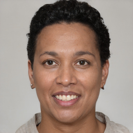 Joyful latino adult female with short  brown hair and brown eyes