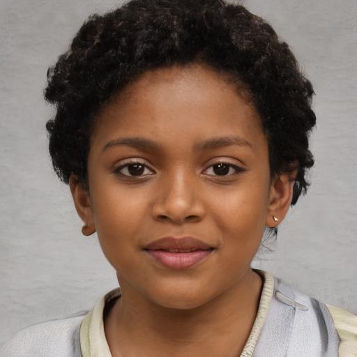 Joyful black child female with short  brown hair and brown eyes