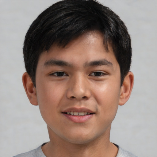 Joyful asian child male with short  brown hair and brown eyes