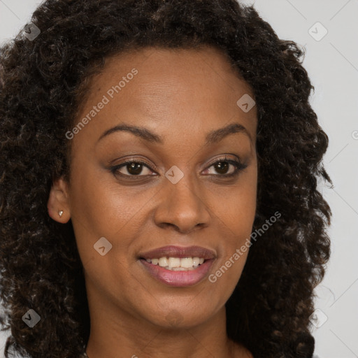 Joyful black young-adult female with long  brown hair and brown eyes