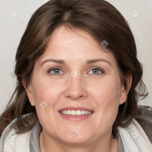 Joyful white adult female with medium  brown hair and blue eyes