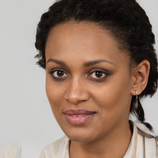 Joyful black young-adult female with short  brown hair and brown eyes