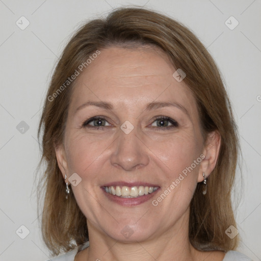 Joyful white adult female with medium  brown hair and grey eyes