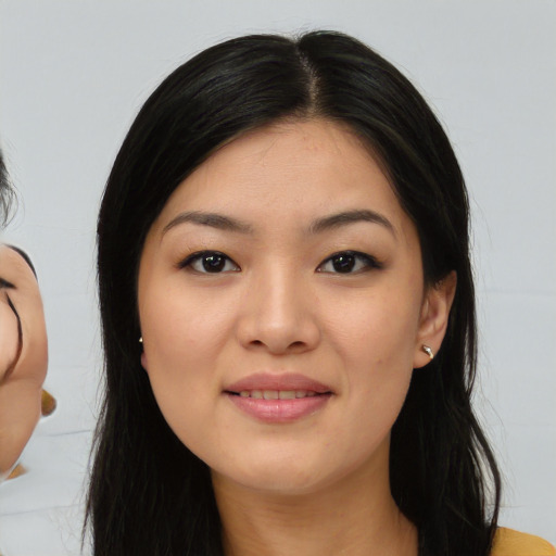 Joyful asian young-adult female with medium  brown hair and brown eyes