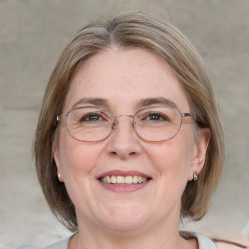 Joyful white adult female with medium  brown hair and blue eyes