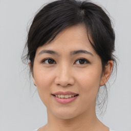 Joyful asian young-adult female with medium  brown hair and brown eyes