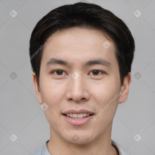 Joyful asian young-adult male with short  brown hair and brown eyes