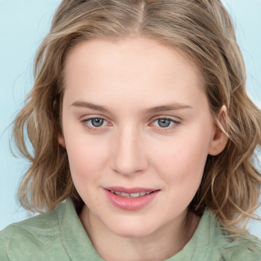 Joyful white young-adult female with medium  brown hair and blue eyes