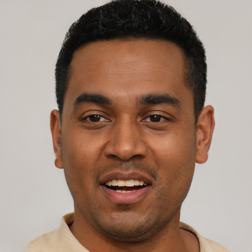 Joyful black young-adult male with short  black hair and brown eyes