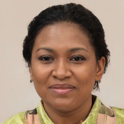 Joyful black adult female with short  brown hair and brown eyes