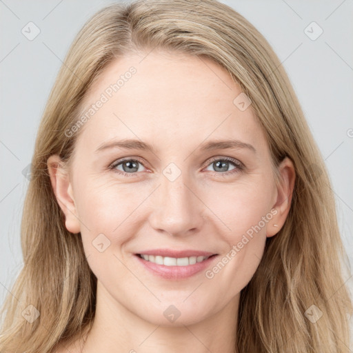 Joyful white young-adult female with long  brown hair and blue eyes