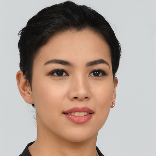 Joyful asian young-adult female with short  black hair and brown eyes