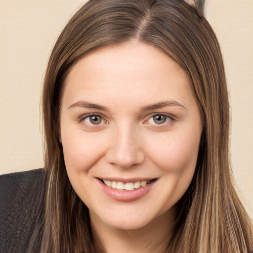 Joyful white young-adult female with long  brown hair and brown eyes