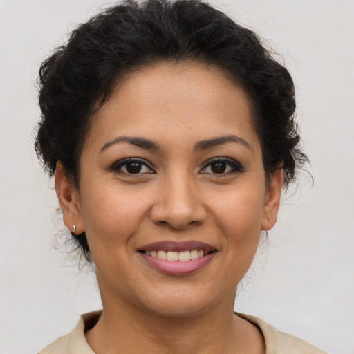 Joyful latino young-adult female with short  brown hair and brown eyes