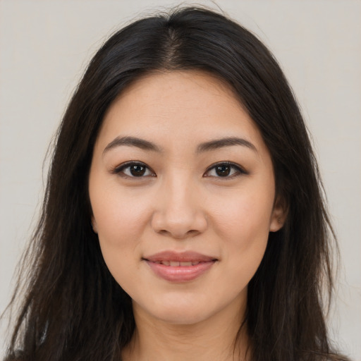 Joyful latino young-adult female with long  brown hair and brown eyes