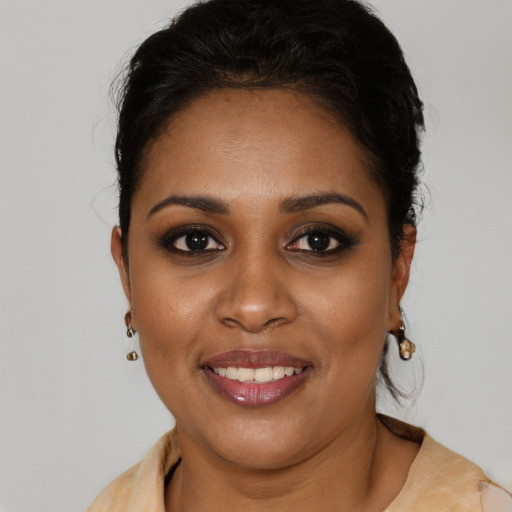 Joyful black young-adult female with medium  brown hair and brown eyes