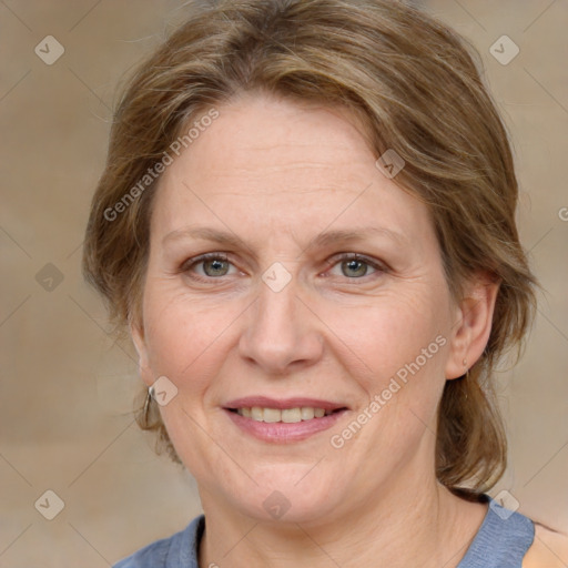 Joyful white adult female with medium  brown hair and grey eyes