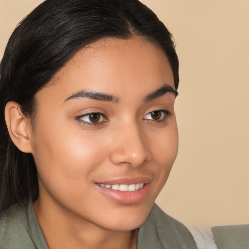 Joyful latino young-adult female with long  brown hair and brown eyes