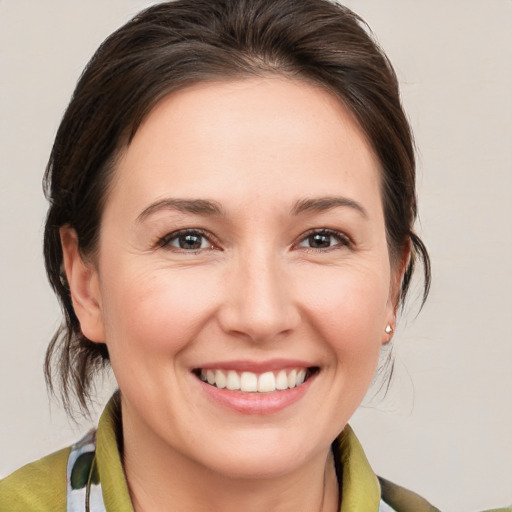 Joyful white young-adult female with medium  brown hair and brown eyes