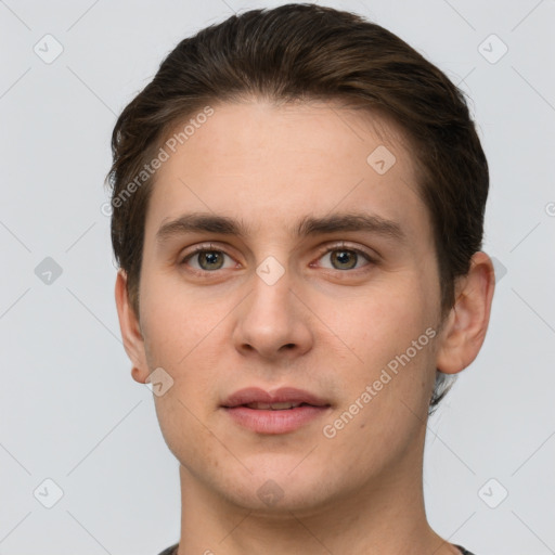 Joyful white young-adult male with short  brown hair and grey eyes