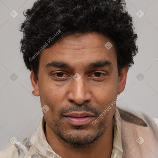 Joyful latino adult male with short  black hair and brown eyes