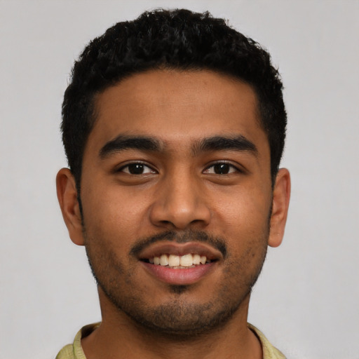 Joyful latino young-adult male with short  black hair and brown eyes