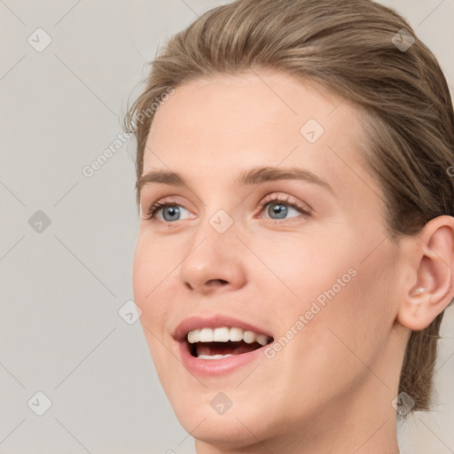 Joyful white young-adult female with medium  brown hair and blue eyes