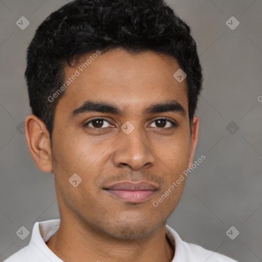 Joyful latino young-adult male with short  brown hair and brown eyes