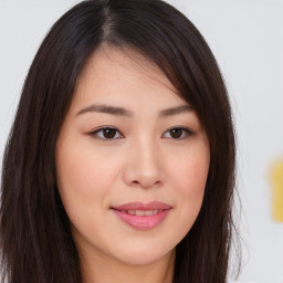 Joyful asian young-adult female with long  brown hair and brown eyes