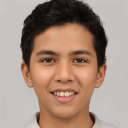 Joyful latino young-adult male with short  brown hair and brown eyes